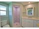 Bright bathroom featuring a white vanity with marble countertop and tiled shower with a window at 19 Oakwood Dr N # 19, Englewood, FL 34223
