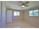 Bedroom featuring neutral walls, ceiling fan, and natural light from windows, offering a bright and airy feel at 19 Oakwood Dr N # 19, Englewood, FL 34223