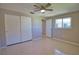 Bedroom featuring neutral walls, ceiling fan, and natural light from windows, with closet and doorway at 19 Oakwood Dr N # 19, Englewood, FL 34223