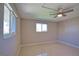 A bright bedroom with two windows and a ceiling fan and light fixture at 19 Oakwood Dr N # 19, Englewood, FL 34223