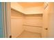 Walk-in closet featuring wooden shelving and rod, providing ample storage space at 19 Oakwood Dr N # 19, Englewood, FL 34223