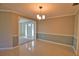 Light-filled dining area with modern chandelier and neutral two-tone paint scheme at 19 Oakwood Dr N # 19, Englewood, FL 34223