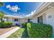 Landscaped front of house showing tidy bushes, walkway and address plaque at 19 Oakwood Dr N # 19, Englewood, FL 34223