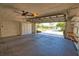 Spacious two-car garage with built-in storage cabinets and a ceiling fan at 19 Oakwood Dr N # 19, Englewood, FL 34223