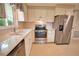 Bright kitchen features stainless steel appliances, white cabinetry, and granite countertops at 19 Oakwood Dr N # 19, Englewood, FL 34223