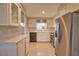 Spacious kitchen showcasing stainless steel appliances and white cabinetry at 19 Oakwood Dr N # 19, Englewood, FL 34223