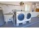 Laundry room with washer, dryer, sink and storage, ideal for household chores at 19 Oakwood Dr N # 19, Englewood, FL 34223