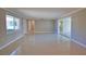 Spacious living room with sleek, polished floors and bright natural light from large windows at 19 Oakwood Dr N # 19, Englewood, FL 34223
