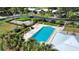 Overhead view of a community pool with lounge chairs and lush landscaping at 19 Oakwood Dr N # 19, Englewood, FL 34223