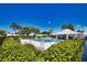 Resort-style community pool with ample seating, a clubhouse and tropical landscaping at 19 Oakwood Dr N # 19, Englewood, FL 34223
