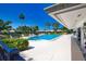 Community pool surrounded by lounge chairs and lush tropical landscaping at 19 Oakwood Dr N # 19, Englewood, FL 34223