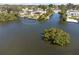Waterfront property with boat dock, screened lanai, lush surroundings, and convenient water access at 2060 Oyster Creek Dr, Englewood, FL 34224