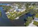 Waterfront property features a boat dock, lush landscaping, and a screened lanai with beautiful water access at 2060 Oyster Creek Dr, Englewood, FL 34224