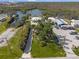 Aerial view of the property showing expansive parking, a boat ramp, and waterfront access at 2060 Oyster Creek Dr, Englewood, FL 34224