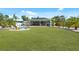 Large backyard with screen enclosed porch and fire pit at 2060 Oyster Creek Dr, Englewood, FL 34224
