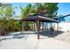 Spacious backyard showcasing a dark metal pavilion structure for outdoor living and entertaining at 2060 Oyster Creek Dr, Englewood, FL 34224