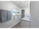 Beautiful bathroom featuring marble countertops, white cabinets, and elegant fixtures at 2060 Oyster Creek Dr, Englewood, FL 34224
