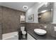 Modern bathroom with tub and shower combo, sleek fixtures, and a stylish vanity at 2060 Oyster Creek Dr, Englewood, FL 34224