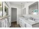 Bathroom features marble countertops, modern fixtures, and a view to the lush outdoors at 2060 Oyster Creek Dr, Englewood, FL 34224