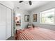 Comfortable bedroom featuring a large window, closet, and cozy decor at 2060 Oyster Creek Dr, Englewood, FL 34224