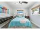 Bedroom with hardwood flooring, bright lighting, and stylish artwork at 2060 Oyster Creek Dr, Englewood, FL 34224