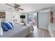 Light and airy bedroom with hardwood flooring and sliding door to outdoor deck at 2060 Oyster Creek Dr, Englewood, FL 34224