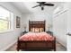 Cozy bedroom with a woven headboard, ceiling fan, and ample natural light at 2060 Oyster Creek Dr, Englewood, FL 34224