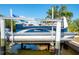 Tahoe boat on lift, ready for waterway adventure at 2060 Oyster Creek Dr, Englewood, FL 34224
