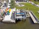 Aerial view of boat lift with boat and jet ski ready for the water at 2060 Oyster Creek Dr, Englewood, FL 34224