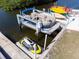 Boat lift and jet ski, with kayaks nearby, is ready for your water fun at 2060 Oyster Creek Dr, Englewood, FL 34224