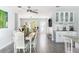 Open dining area with bright windows, decorative bar, and elegant furnishings at 2060 Oyster Creek Dr, Englewood, FL 34224