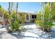 Welcoming front entrance featuring a covered porch and tropical landscaping, creating a serene setting at 2060 Oyster Creek Dr, Englewood, FL 34224