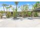 Charming home with lush landscaping, a metal roof, and a welcoming front porch with seating at 2060 Oyster Creek Dr, Englewood, FL 34224