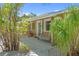 Inviting front porch featuring a hanging swing, decorative plants, and a charming entrance at 2060 Oyster Creek Dr, Englewood, FL 34224