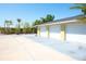 Three-car garage with a spacious driveway and lush landscaping, offering ample parking and storage at 2060 Oyster Creek Dr, Englewood, FL 34224
