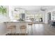 Open concept kitchen with stainless steel appliances, bar seating, and seamless flow to the outdoor patio at 2060 Oyster Creek Dr, Englewood, FL 34224