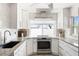 Well-lit kitchen featuring stainless steel appliances, ample counter space, and white cabinetry at 2060 Oyster Creek Dr, Englewood, FL 34224