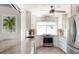 Modern kitchen with stainless steel appliances, white cabinets, and sleek countertops under recessed lighting at 2060 Oyster Creek Dr, Englewood, FL 34224