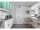 Bright kitchen with white cabinets, stone countertops, modern appliances, and stylish bar seating at 2060 Oyster Creek Dr, Englewood, FL 34224