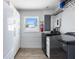 Well-organized laundry room with modern washer and dryer, storage cabinets, and a bright window at 2060 Oyster Creek Dr, Englewood, FL 34224