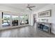 View of bright living room with sliding door to outdoor patio with a scenic view at 2060 Oyster Creek Dr, Englewood, FL 34224
