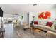 Bright and airy living room with stylish decor, wood-look tile flooring, and access to an outdoor space at 2060 Oyster Creek Dr, Englewood, FL 34224