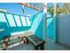 Inviting outdoor shower with benches, a white-pebbled floor, blue walls, and a charming design at 2060 Oyster Creek Dr, Englewood, FL 34224