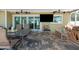 This comfortable covered patio has a table, chairs, and seating, as well as a flat-screen television at 2060 Oyster Creek Dr, Englewood, FL 34224