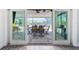 View from indoors to an outdoor patio perfect for entertaining with scenic backyard at 2060 Oyster Creek Dr, Englewood, FL 34224