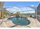 The screened-in pool area has a beautiful pool, outdoor seating, and a view of the water at 2060 Oyster Creek Dr, Englewood, FL 34224