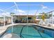 The pool area has both a pool and covered patio, making it great for relaxation and entertainment at 2060 Oyster Creek Dr, Englewood, FL 34224