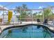 The screened-in pool area has a beautiful pool, outdoor seating, and great privacy with mature landscaping at 2060 Oyster Creek Dr, Englewood, FL 34224