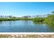 Enjoy tranquil water views surrounded by lush trees and a clear blue sky at 2060 Oyster Creek Dr, Englewood, FL 34224