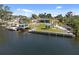Waterfront property with lush green grass and boat lift at 2060 Oyster Creek Dr, Englewood, FL 34224